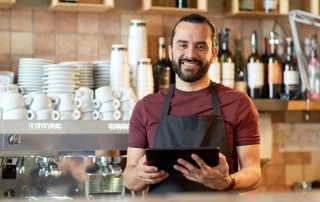 man with tablet behind counter