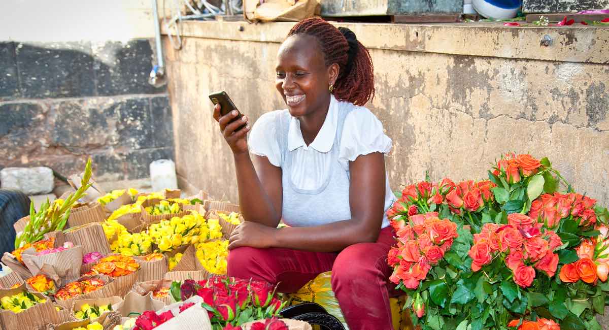 woman in market in Nairobi selling flowers