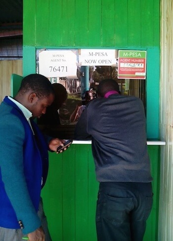 M-PESA agent with people queuing outside