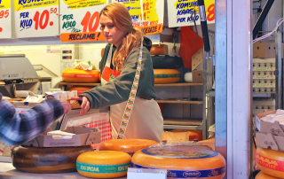 Dutch cheese stall woman being handed a card for payment