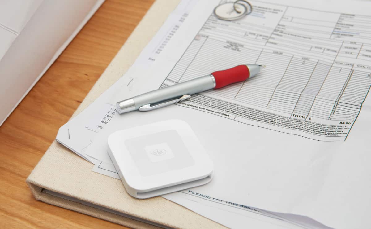 Square Reader on top of self-employed paperwork