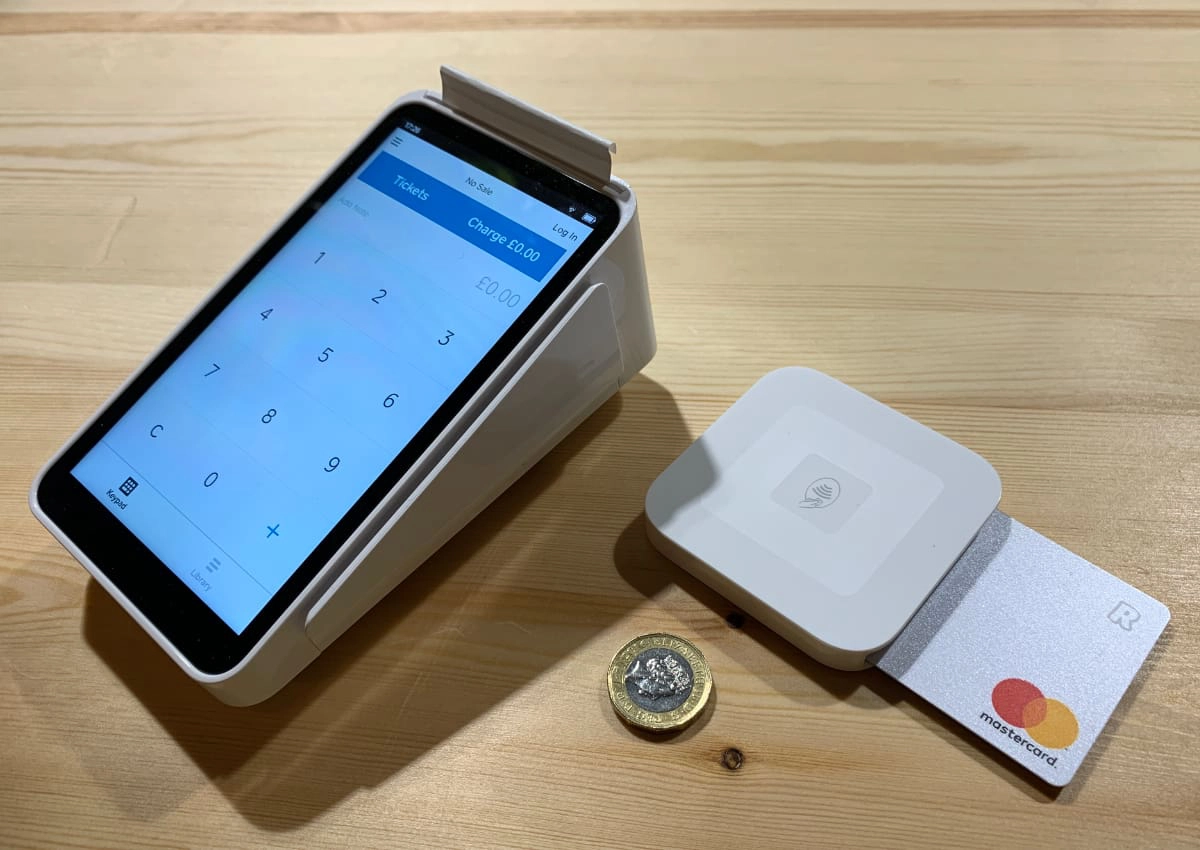 Square Terminal and Square Reader next to coin