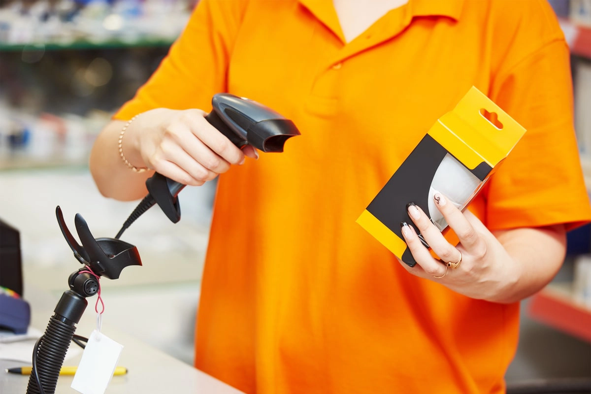 retail worker scanning a product with a barcode scanner