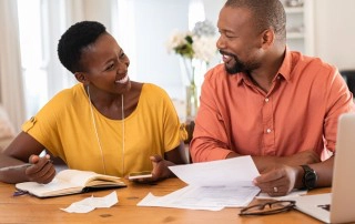 smiling couple looking at finances
