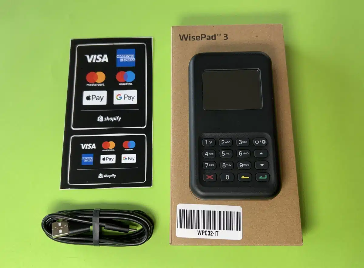 Shopify card reader on box and next to decals and charging cable