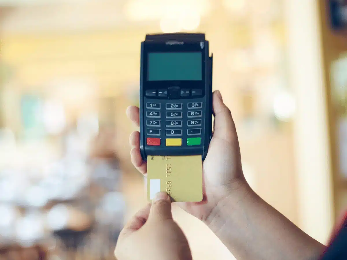 hand inserting credit card into card machine