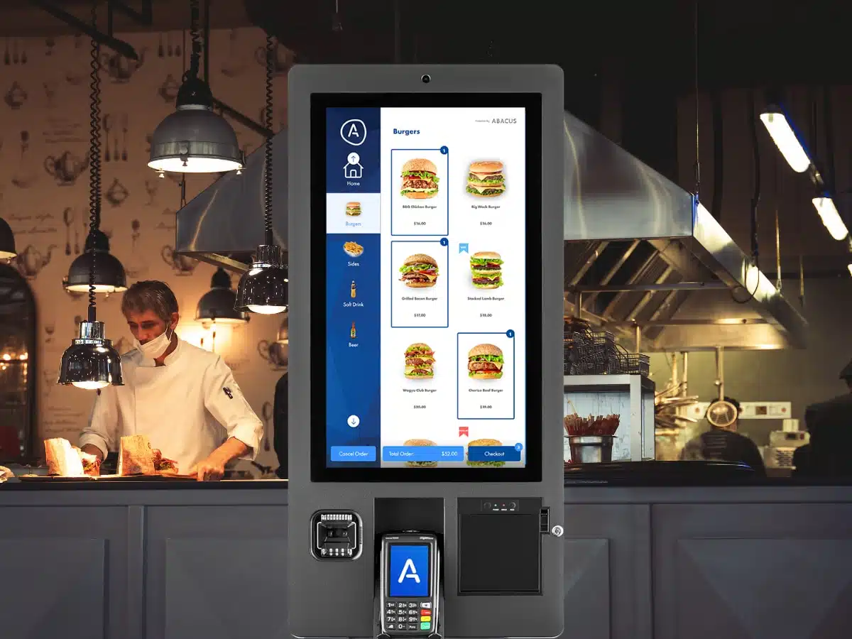 Abacus Self-Ordering Kiosk in front of a restaurant kitchen