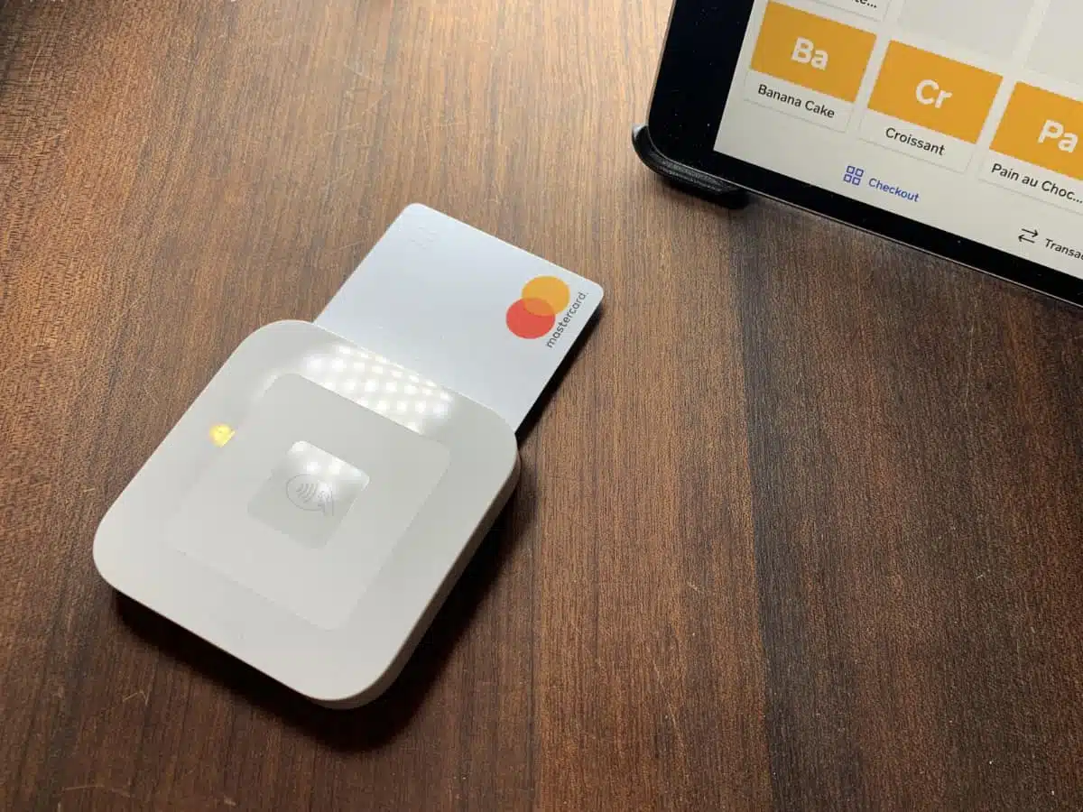 Square Reader connects wirelessly with a Square POS app on a mobile device Square Reader accepting a chip card next to corner of an iPad