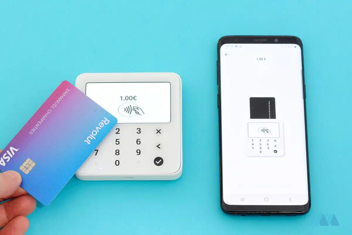 We tested SumUp Solo Lite, here being tapped with our Revolut card to pay SumUp Solo Lite card reader with a contactless tap with a Revolut card, next to a smartphone with SumUp App