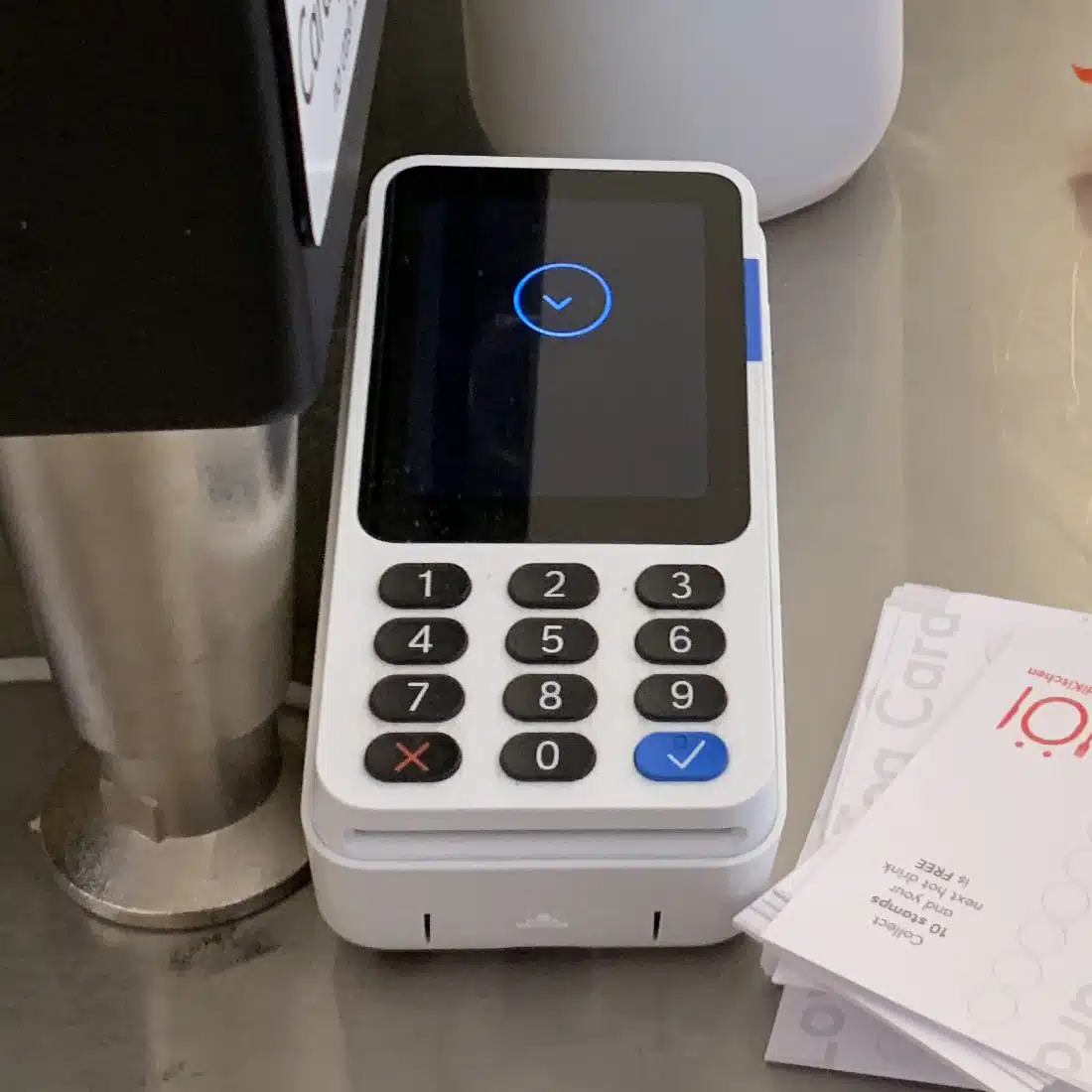 PayPal Reader is compact and neutral-looking PayPal Reader on a cafe countertop