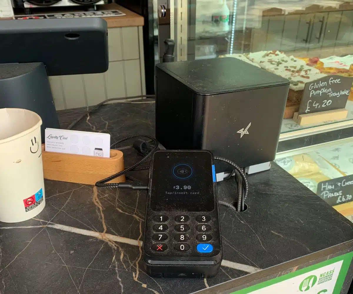 PayPal Reader with PayPal’s free POS system in a cafe A black PayPal Reader blends in well on a black countertop